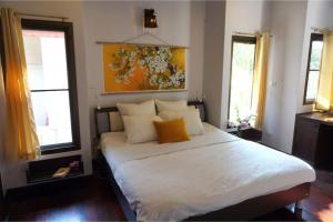 a bedroom with a large white bed with two windows at Southern Lanta A4 in Ko Lanta +14 photos
