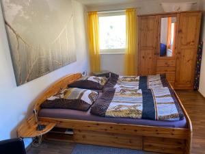 a bed in a bedroom with a wooden frame at Fewo 4 in Markkleeberg
