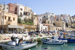 a group of boats are docked in a harbor at Le Plejadi in Castellammare del Golfo