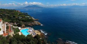 an aerial view of a resort and the ocean at Baia delle Rocce Verdi Resort in Naples