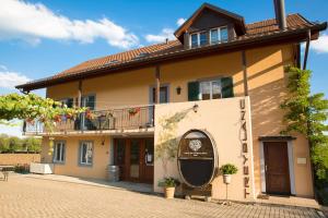 a house with a balcony on the side of it at Cave Du Treyblanc in Luins
