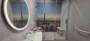 a bathroom with a shower with a view of the ocean at Le Relais de la Comté in Portbail +128 photos