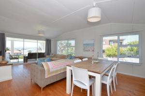 a living room with a table and a couch at Kommaweer in Yzerfontein