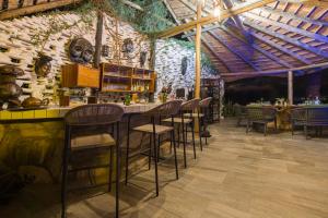 a bar in a restaurant with a stone wall at Ohorongo Safari Lodge in Kamanjab