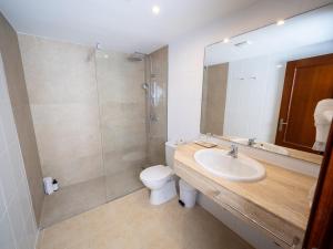a bathroom with a toilet and a sink and a shower at Prope Mare Apartamentos in Cala Millor +45 photos