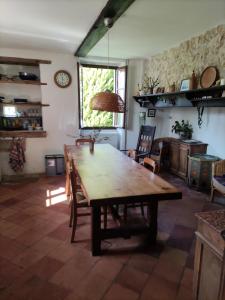a dining room with a wooden table and chairs at "Hertou" in Clèdes
