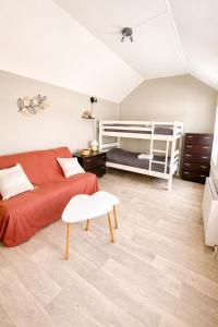a living room with a bed and a couch at Le Refuge du Mans in Le Mans