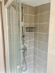 a shower in a bathroom with a glass door at Le Refuge du Mans in Le Mans +8 photos