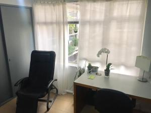 a office with a desk and a chair and a window at Apartment Cozy room in Mexico City