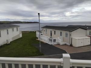 a row of houses on the shore of a body of water at The Bay View in Eyemouth