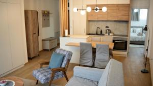 a kitchen and living room with a table and chairs at Apartman Jančić in Loznica