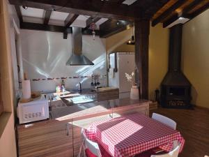 a kitchen with a table and a sink and a stove at La Casuca in Celucos