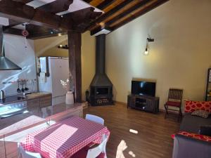 a living room with a table and a fireplace at La Casuca in Celucos