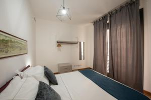 a bedroom with a white bed and a window at U Genova in Genoa