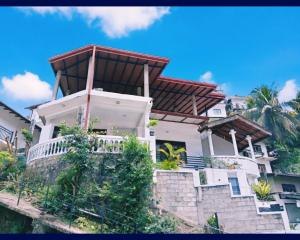 a house on a hill with a roof at Chandi Mahal HomeStay in Kandy