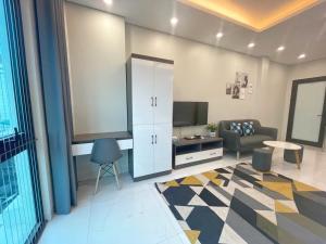 a living room with a couch and a tv in a room at CH home apartment in Hanoi