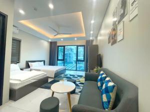 a living room with a couch and a bed and a table at CH home apartment in Hanoi
