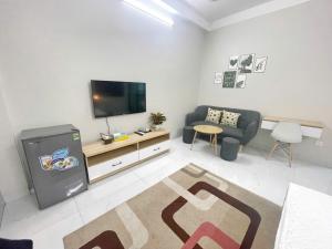 a living room with a television and a couch at CH home apartment in Hanoi