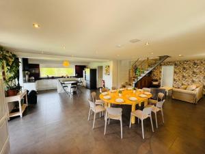 a dining room and living room with a table and chairs at La Maison de Benjamin in La Chapelle-Saint-Aubert +75 photos