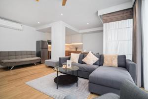 a living room with a couch and a table at Laguna Beachside Residences Building 2 by Banyan Living in Bang Tao Beach