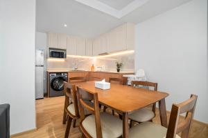 a kitchen and dining room with a wooden table and chairs at Laguna Beachside Residences Building 2 by Banyan Living in Bang Tao Beach +27 photos