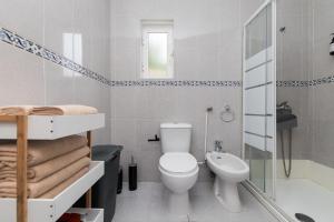 a bathroom with a toilet and a shower and a sink at Peaceful Retreat near Sesimbra and Meco Beach - MADA HOUSE's II in Sesimbra +44 photos