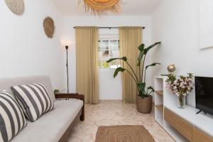 a living room with a couch and a tv at Peaceful Retreat near Sesimbra and Meco Beach - MADA HOUSE's II in Sesimbra