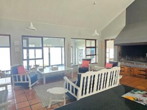 a living room with chairs and a fireplace at Ocean View Drive 150 in Struisbaai