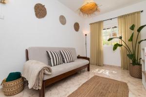 a living room with a couch and a plant at Peaceful Retreat near Sesimbra and Meco Beach - MADA HOUSE's II in Sesimbra