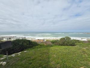 a view of a beach with the ocean in the background at Ocean View Drive 150 in Struisbaai +5 photos