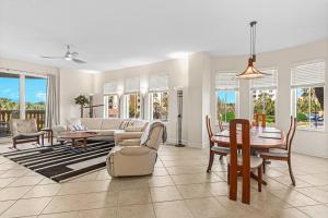 a living room with a couch and a table and chairs at Coastal Serenity Spacious 3Br Condo In Minorca in New Smyrna Beach