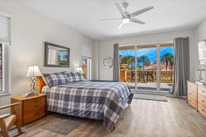 a bedroom with a bed and a ceiling fan at Coastal Serenity Spacious 3Br Condo In Minorca in New Smyrna Beach +32 photos