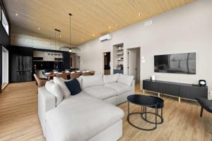 a living room with a white couch and a table at Spa & Panoramic Nature Views - Alto in Saint Come +50 photos