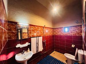 a bathroom with a sink and a toilet at Les Roses Des Dunes in Merzouga +46 photos