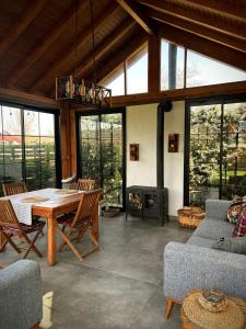 a living room with a table and a fireplace at Abant Cozy Homes in Bolu