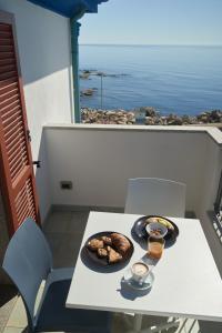 a plate of food on a table on a balcony at Il Nuovo Gabbiano in Cala Gonone