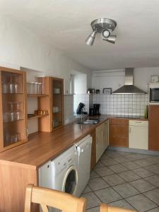 a kitchen with a washing machine in the middle at Haus Janne in Zell an der Mosel