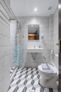 a white bathroom with a sink and a toilet at Mironi & Victoria in Limenas