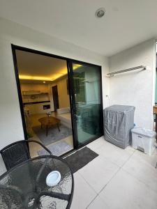 a patio with a table and a view of a room at The Title Rawai in Ban Saiyuan (1) +7 photos