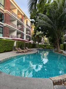 a swimming pool in front of a apartment building at The Title Rawai in Ban Saiyuan (1)