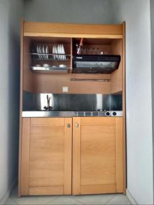 a kitchen with wooden cabinets and a stove at Mironi & Victoria in Limenas +27 photos