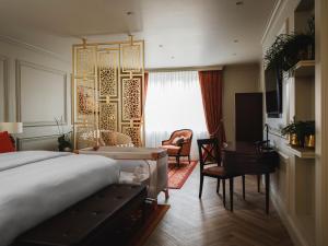 a hotel room with a bed and a desk at Taj Hessischer Hof Frankfurt in Frankfurt +63 photos