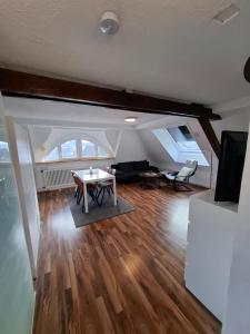 an attic living room with a table and a couch at Ferienwohnung Jule in Grenzach-Wyhlen