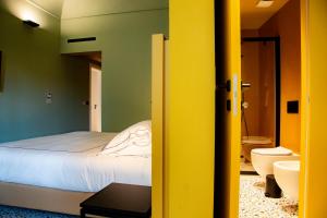 a bedroom with a bed and a bathroom at Ghibellini Rooms in Palazzolo Acreide +58 photos