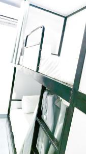 a ladder in a room with a white bunk bed at Tam Cốc Diện Hoa Hotel & Restaurant in Văn Lâm