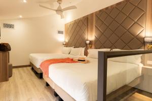 a hotel room with two beds and a headboard at GOLDEN TULIP CANNES HOTEL de PARIS in Cannes +208 photos