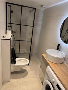 a bathroom with a sink and a toilet at Hybel in Porsgrunn