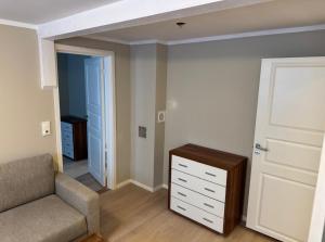 a living room with a couch and a dresser at Hybel in Porsgrunn