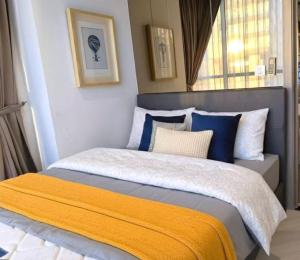 a bedroom with a bed with blue and white pillows at Andromeda Condominium Pattaya in Pattaya South +110 photos