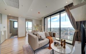 a living room with a couch and a table at Andromeda Condominium Pattaya in Pattaya South